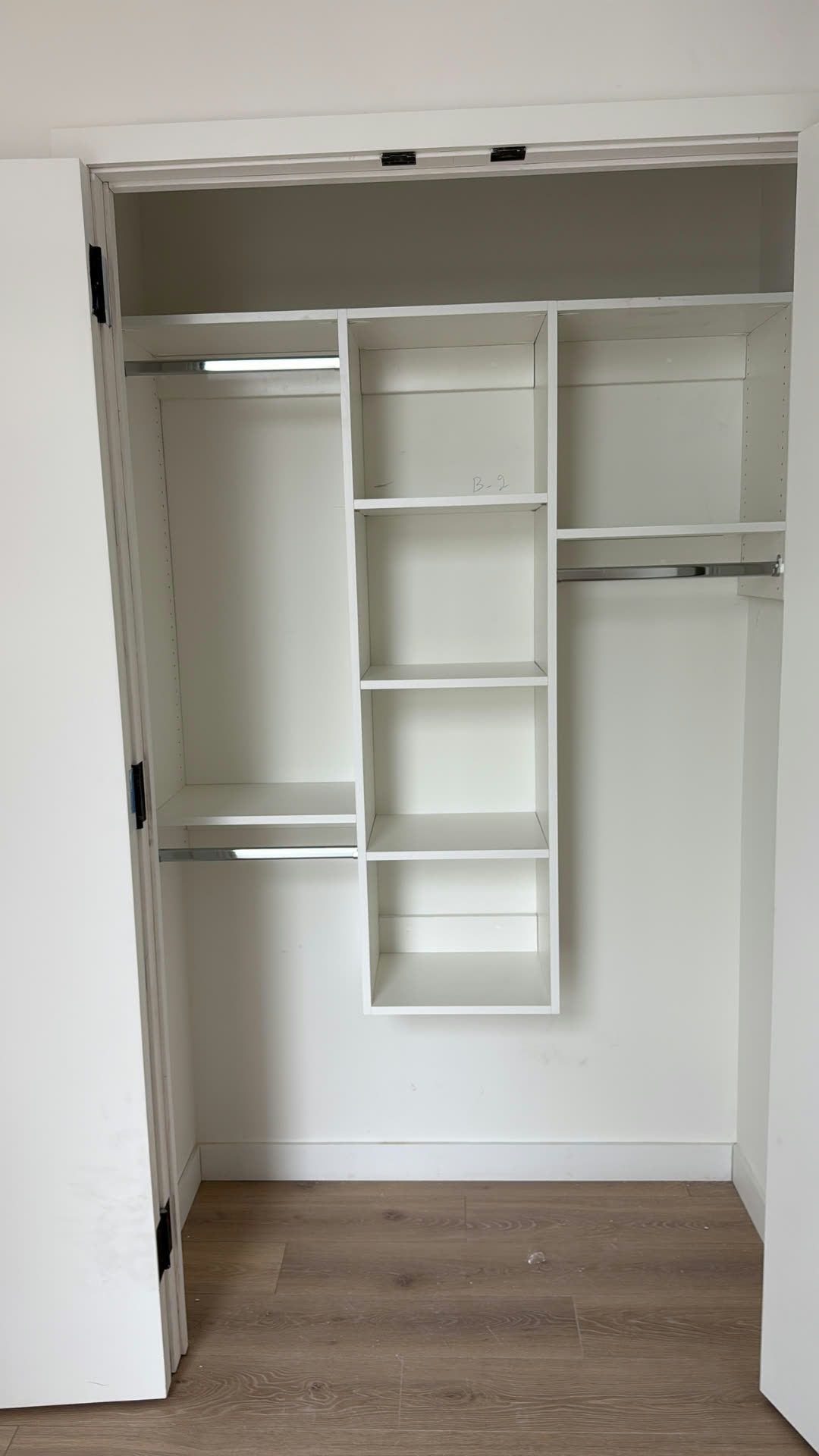 Custom fitted closet with open shelving and hanging rods