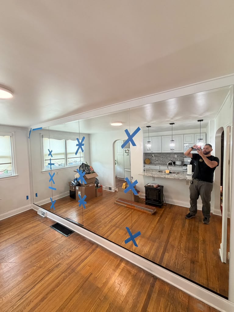 Floor to ceiling wall mirror panels installed in a New Jersey living room
